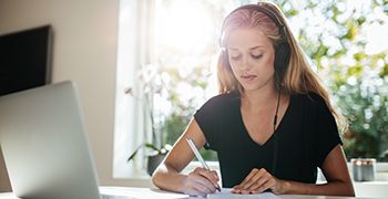A woman works at a laptop