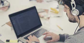 Student writing their literature review on a laptop